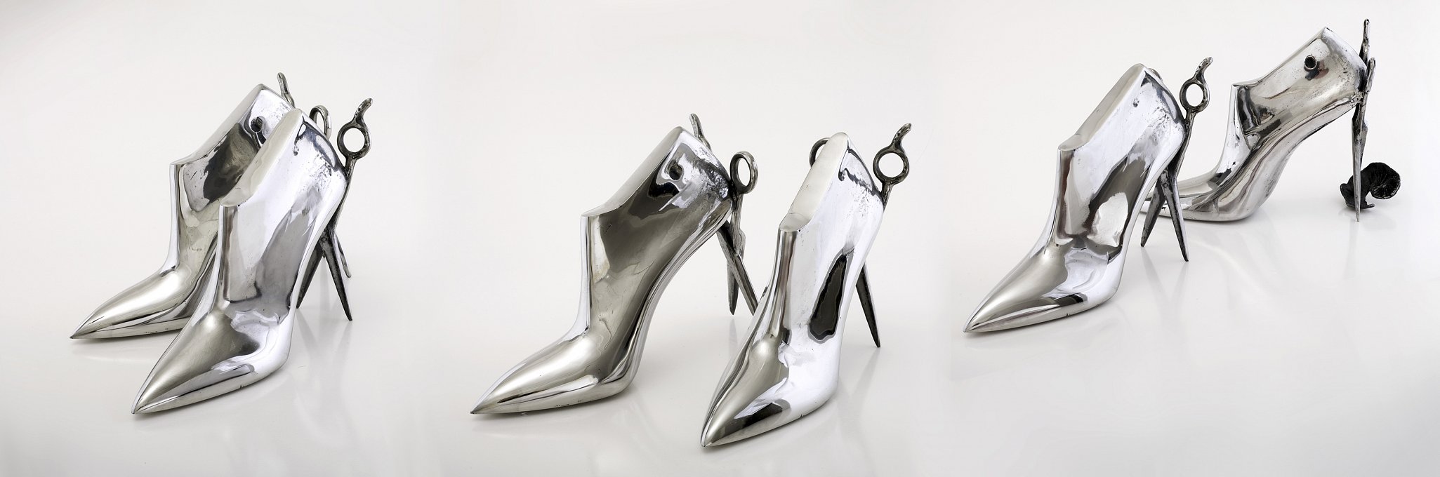 Catwalk,Three pairs of cast stainless steel shoes with scissor heels
