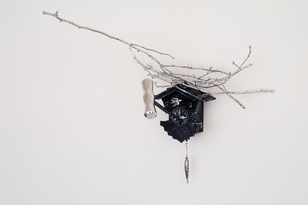 No Flying From Fate,chromed cuckoo clock, twigs and cork screw, stainless steel wire, cast stainless steel, paint.